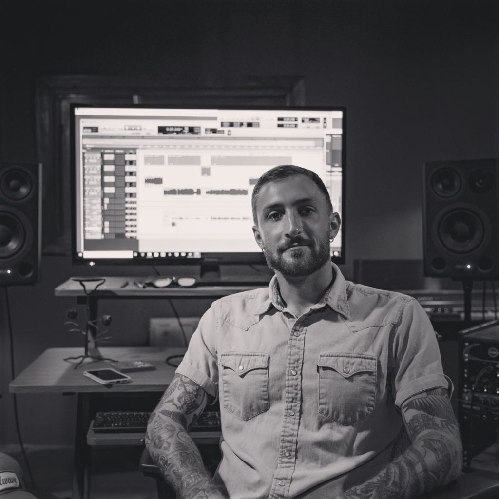 Alex Meylink sitting at the desk in the control room at Stillwave recording studio in Milwaukee