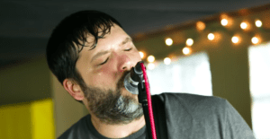 Ryan Young of Off With Their Heads singing into a microphone