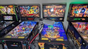 A microphone in front of pinball machines.